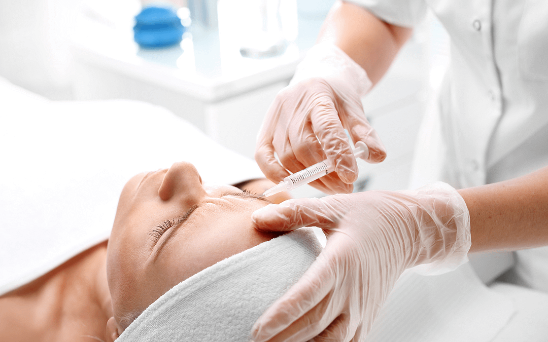 female receiving aesthetics treatments in white environment