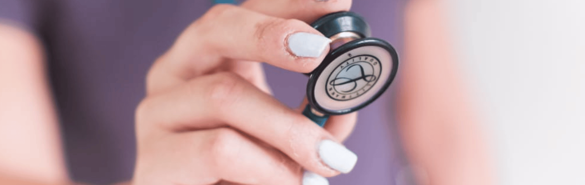 Hand holding stethoscope close up to camera